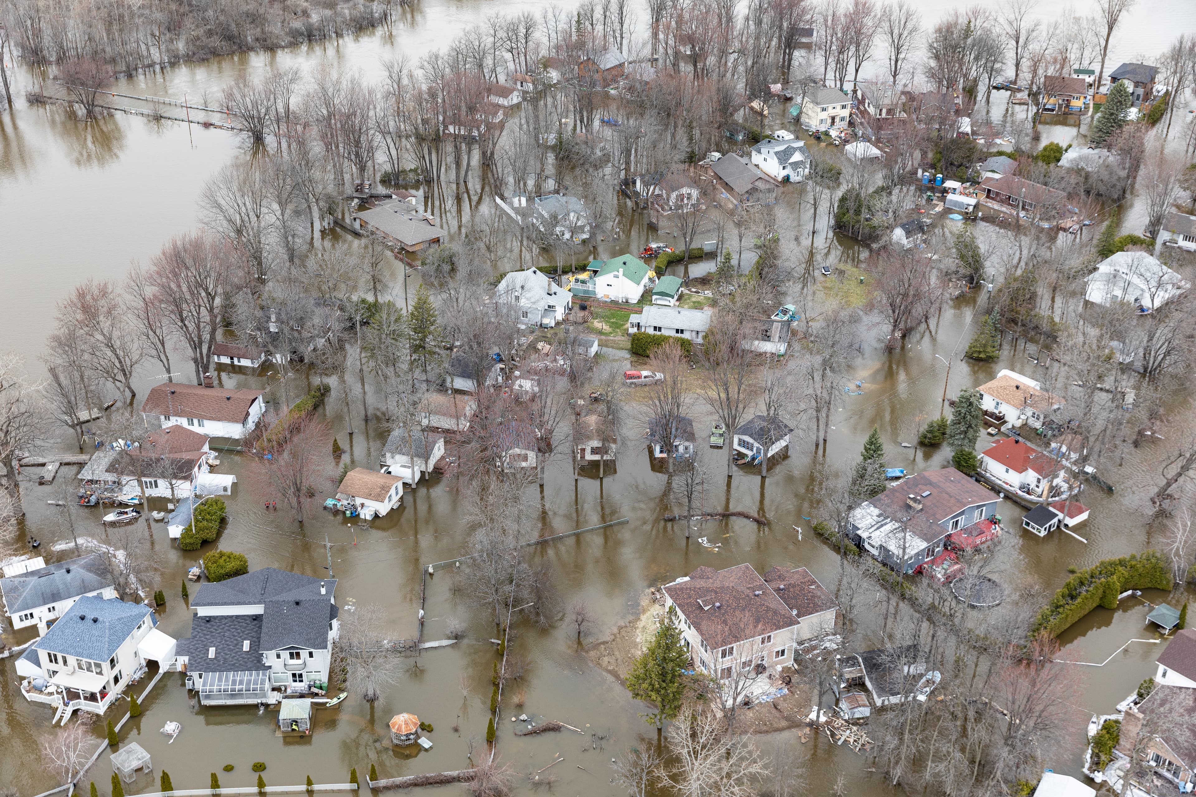 Aerial view of a flooded residential area with submerged homes and streets.